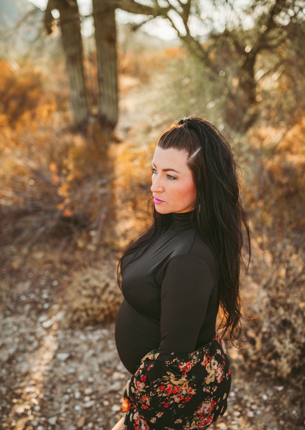 a pregnant women posing at sunset for a maternity session with heidi grace photography