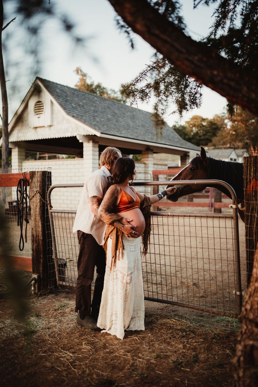 a man cuddling with his pregnant wife