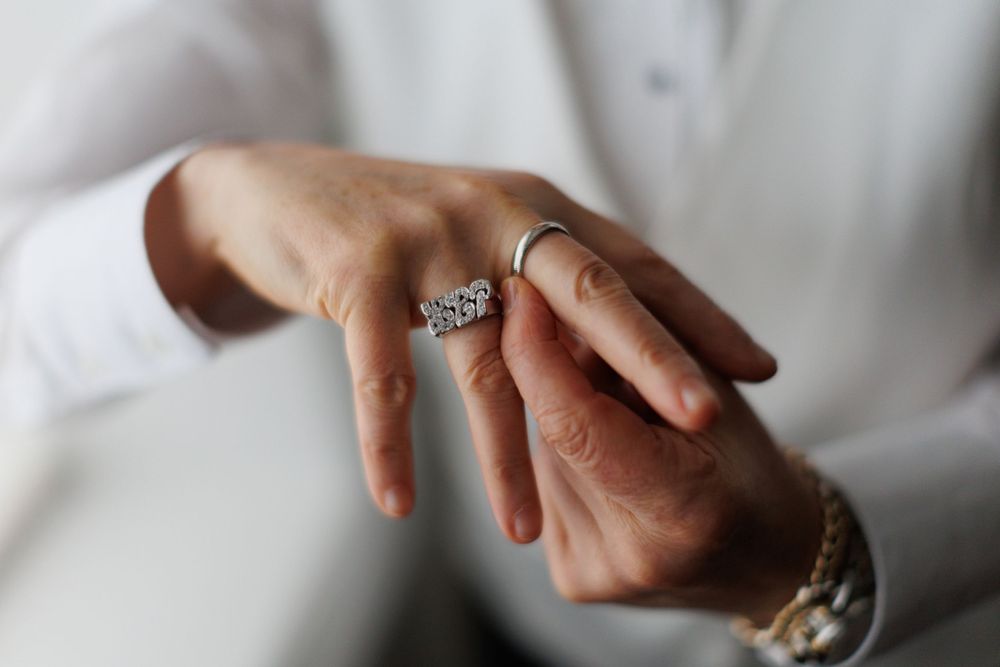 Close-up detail shot of a sparkling diamond engagement ring on hand.