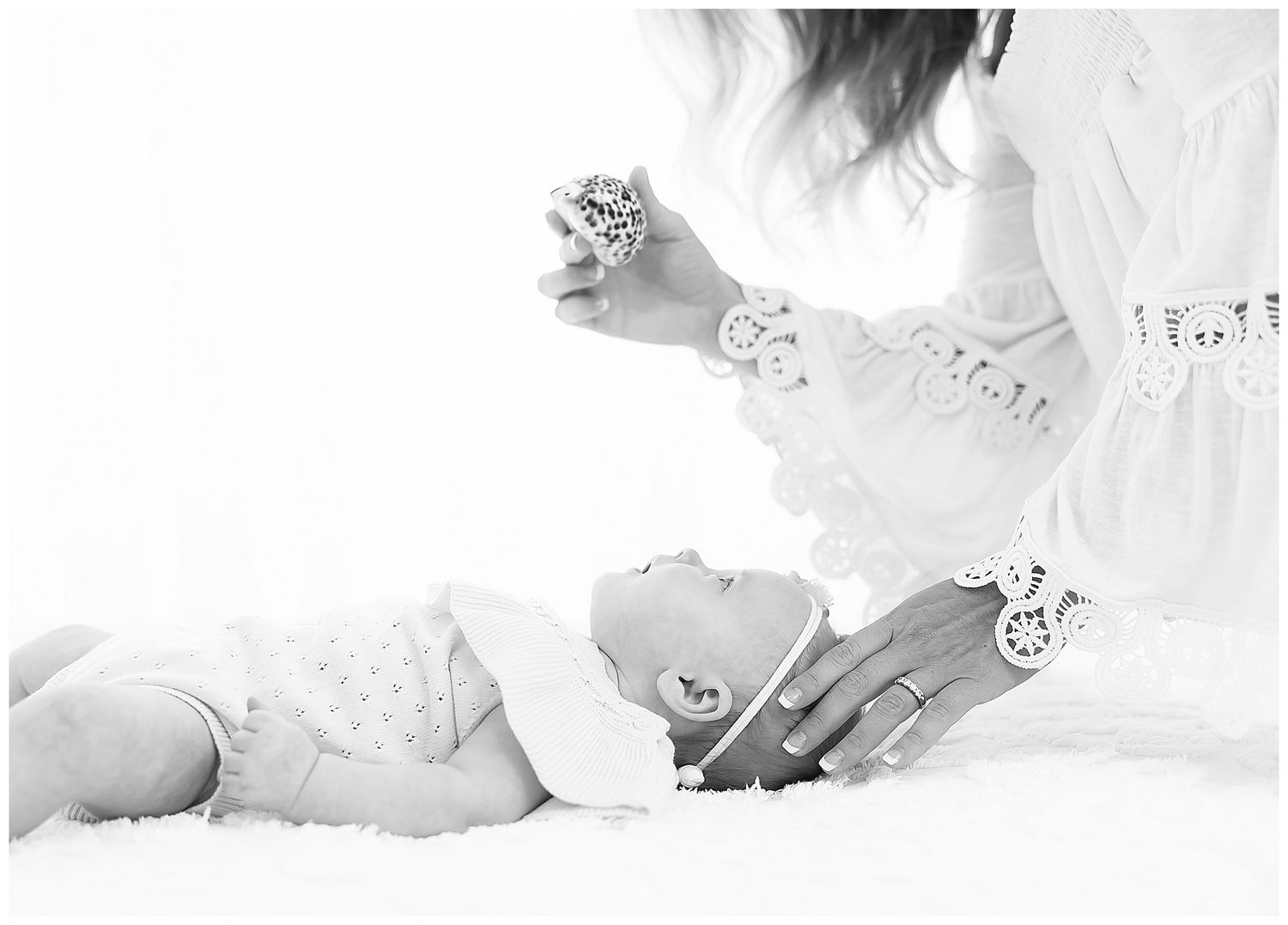 mother standing above baby in front of a window, chattanooga baby photographer, east ivy photography, liza reifsnyder