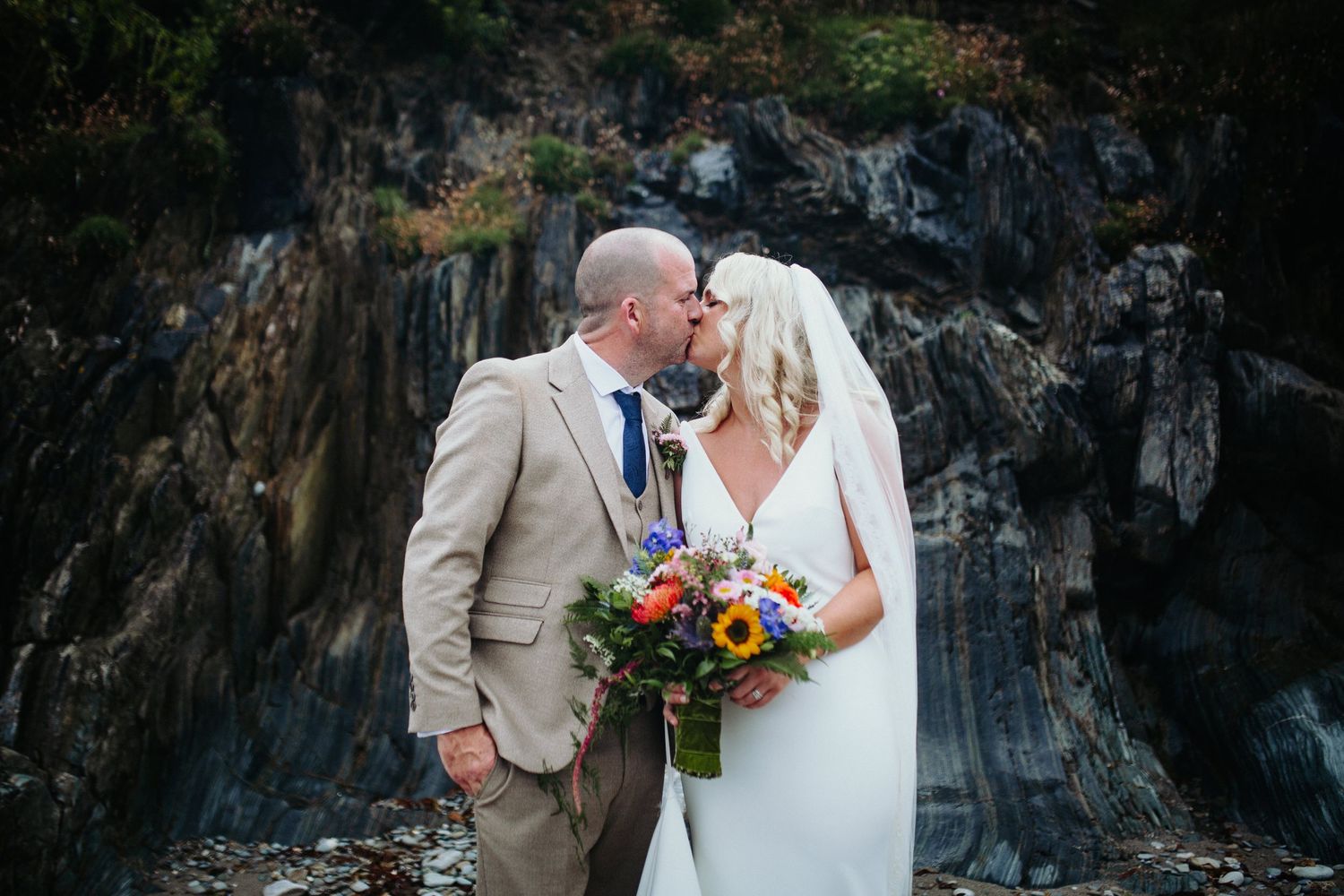 first kiss on the beach in West Cork wedding venue Dunmore House