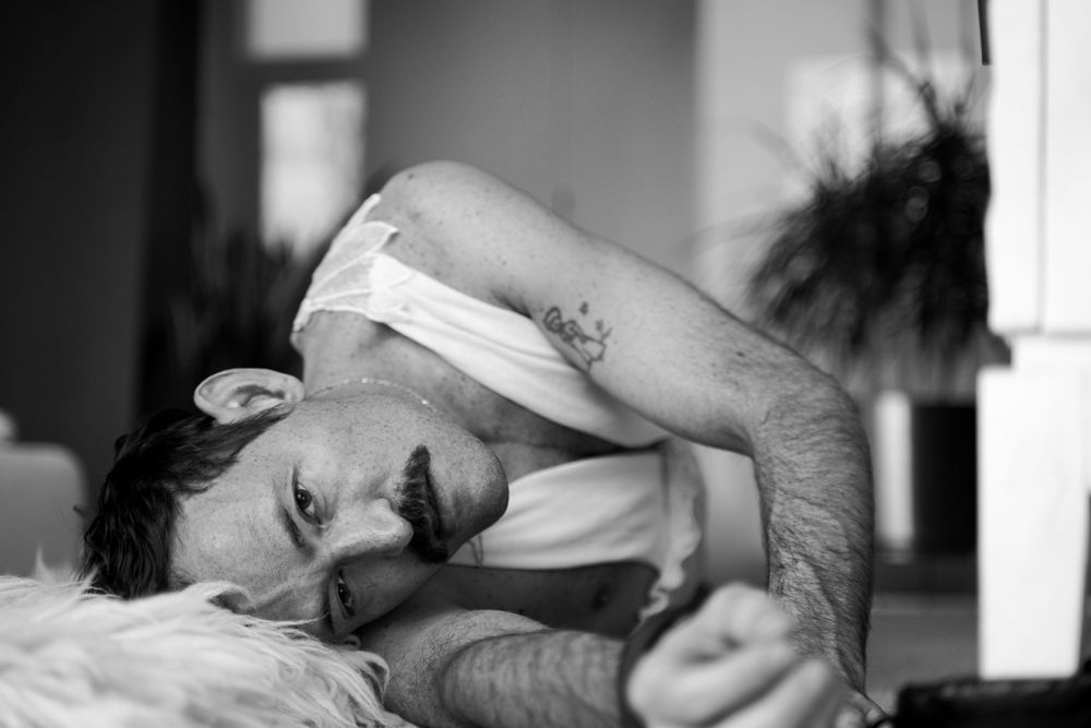 Intimate black and white portrait of person lying down.