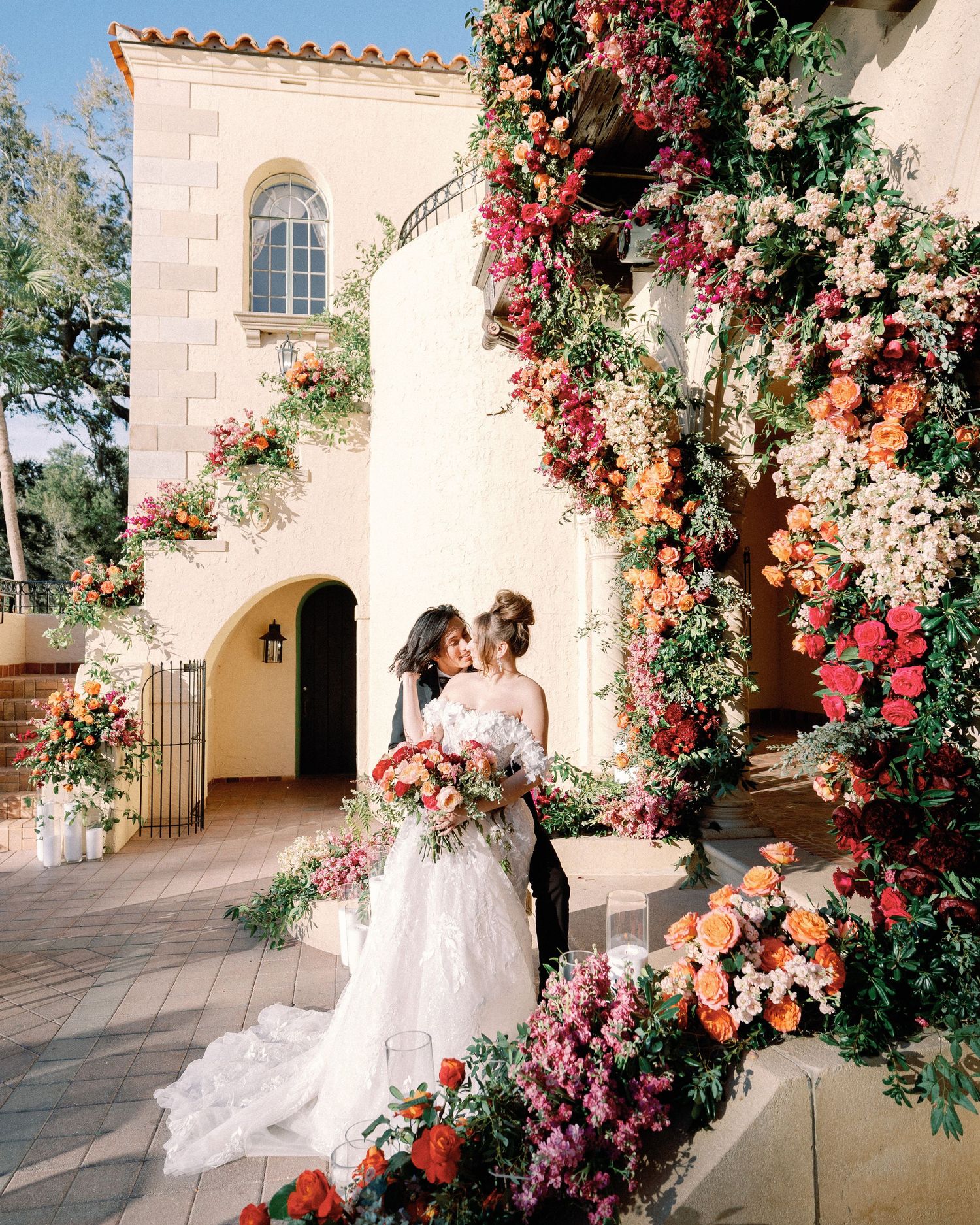 High-end editorial wedding photoshoot showcasing gorgeous floral designs on the grand staircase of Powel Crosley Estate