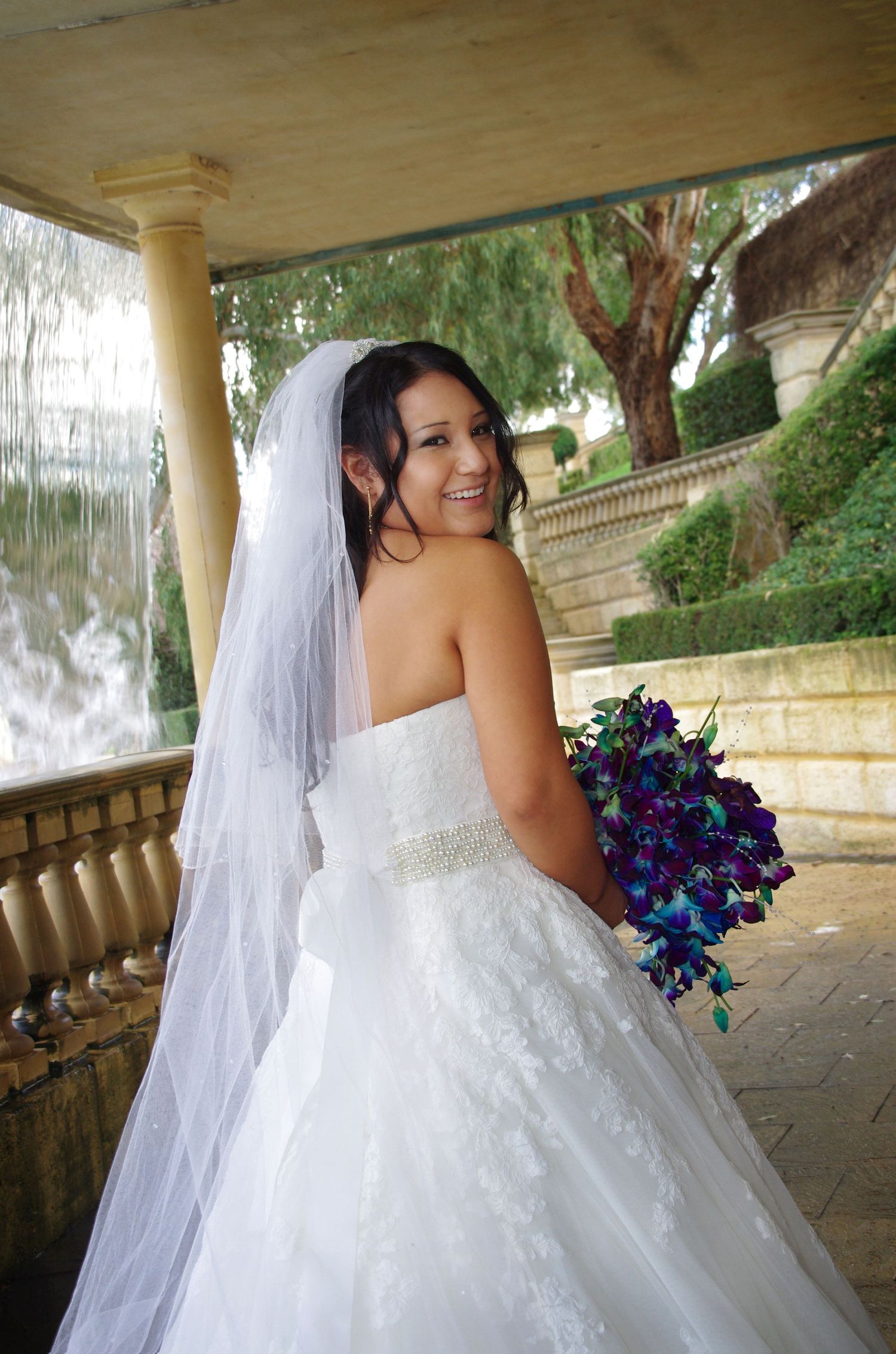 bride looking over shoulders smiling at caversham house