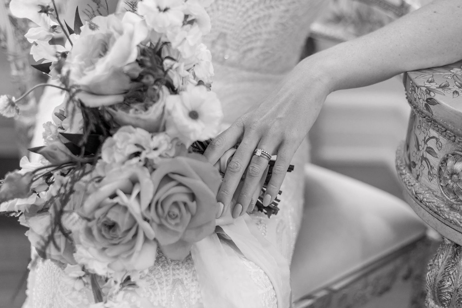 up close black and white detail shot of a brides bouquet and her wedding ring