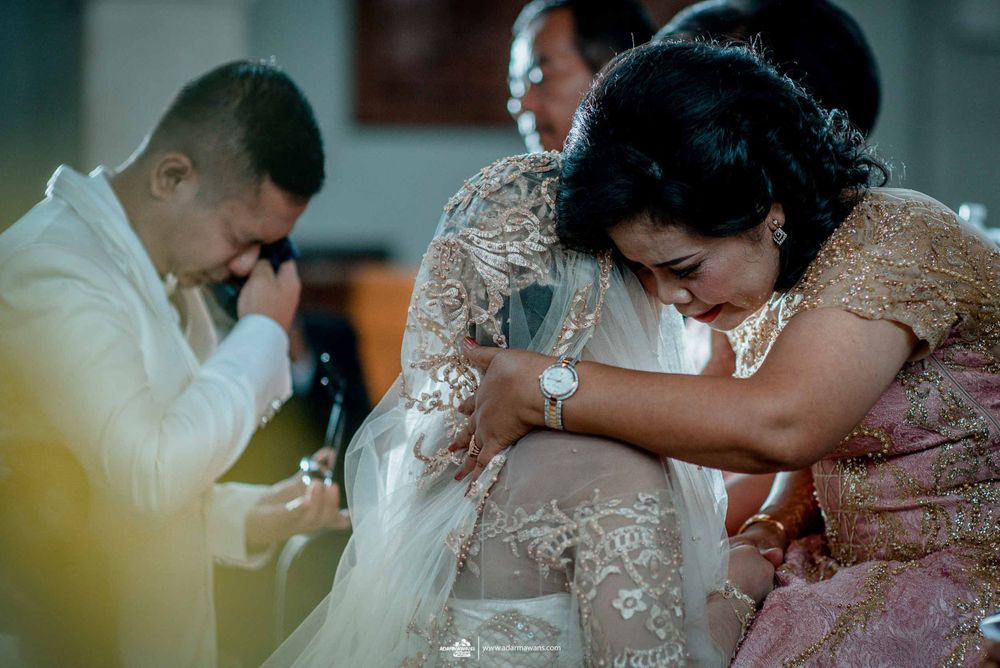 An emotional moment during a wedding ceremony as attendees gather in close embrace.