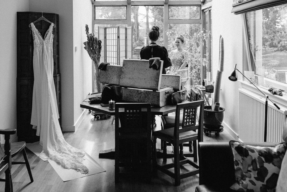 Interior of bridal preparation room with natural light streaming through windows.