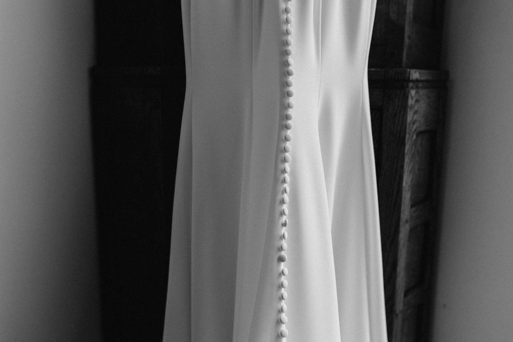 Elegant white wedding dress hanging in preparation for the big day.
