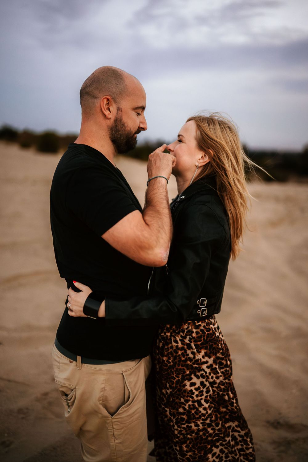 An intimate embrace shared between a couple on a cloudy day at the fóti-sivatag.
