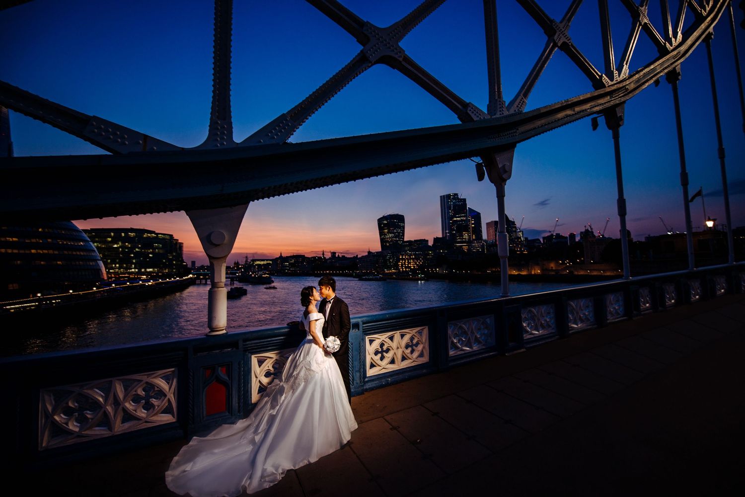 Pre-wedding couple with the river Thames behind them at dusk