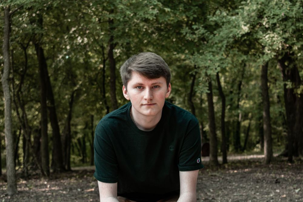 Portrait series in wooded setting with natural lighting and trees in background.