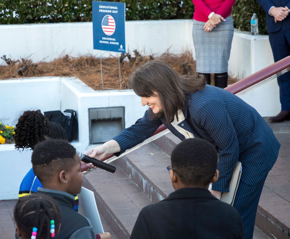 Students interact with school program materials during Educational Freedom Day event.