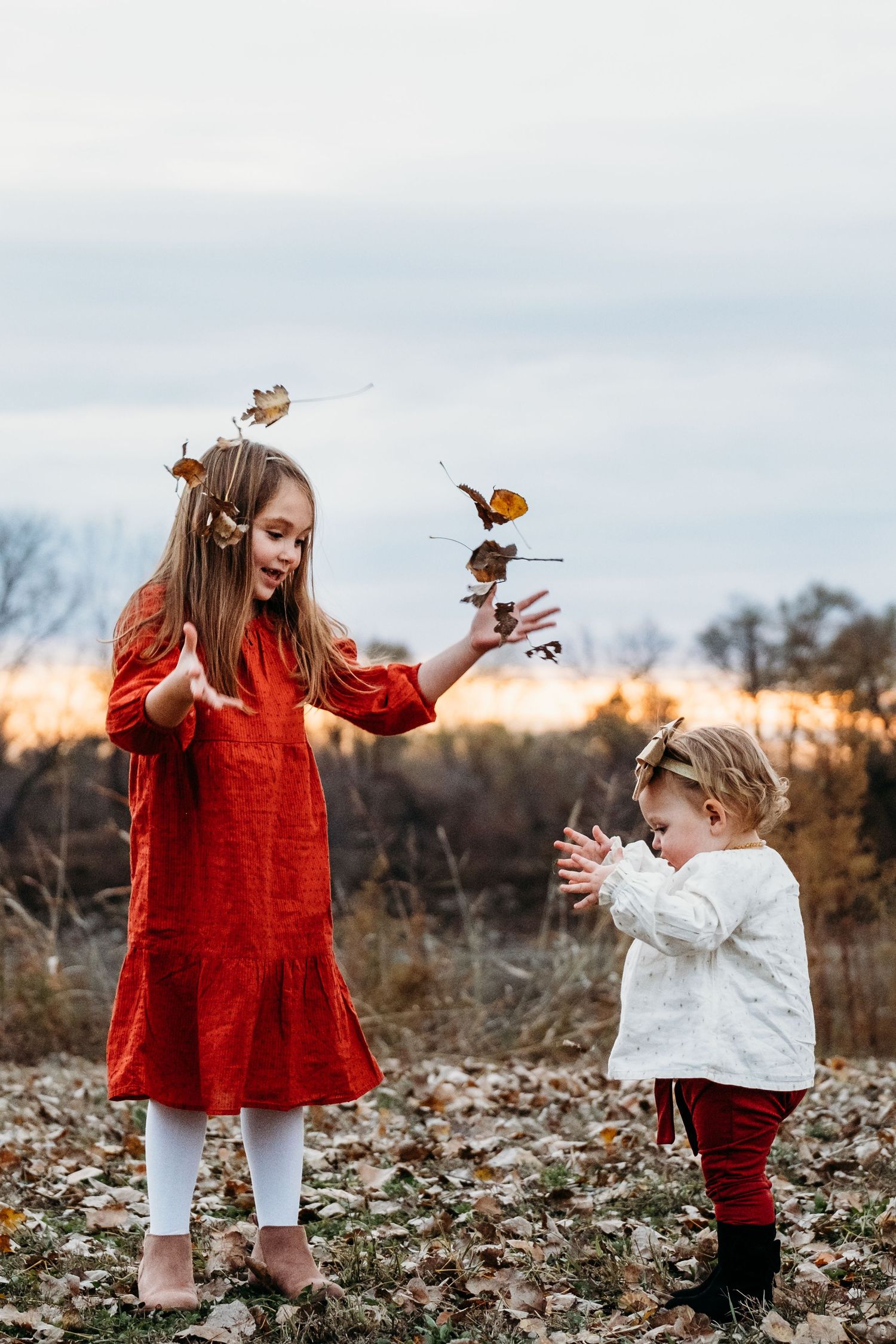 Children play together at the River Walk in St. Joseph, Missouri during a family photography session.