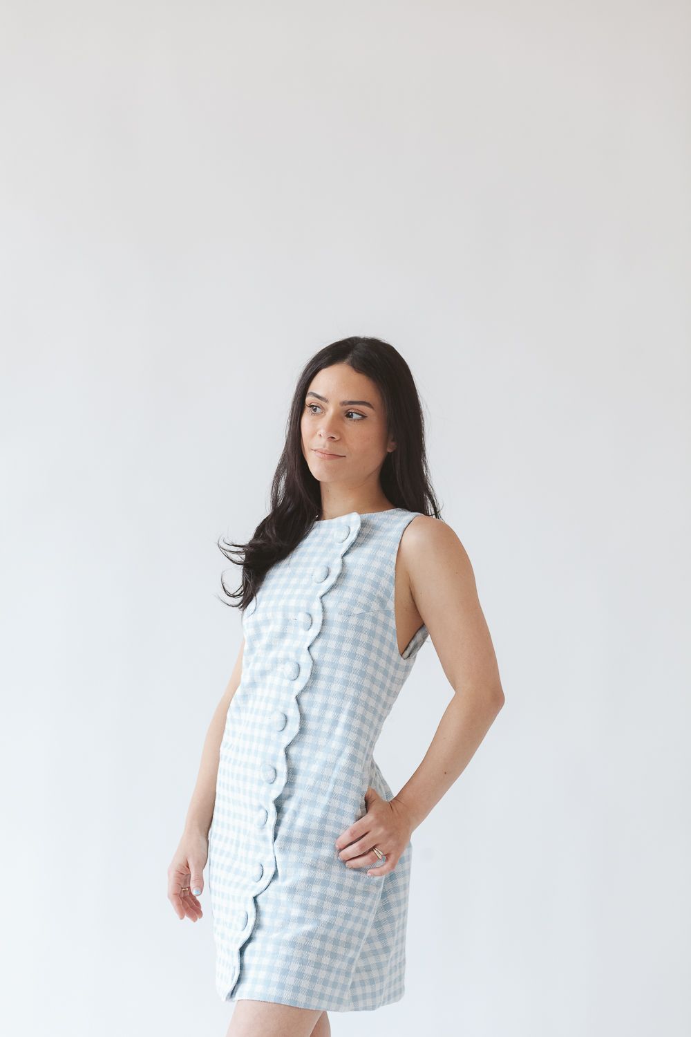 a half body view of artist Aniella Ernandez wearing a Lisa Marie Fernandez  dress during a branding photoshoot in NYC