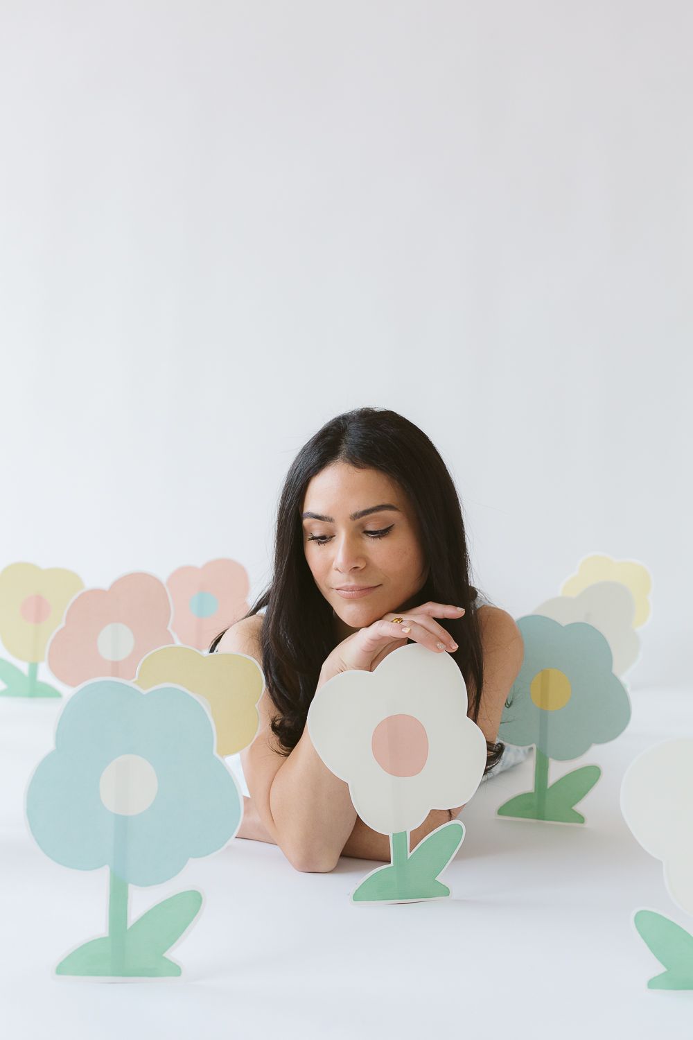 a candid view of illustrator artist Aniella Ernandez next to her paper flowers during a branding session in NYC by Paula