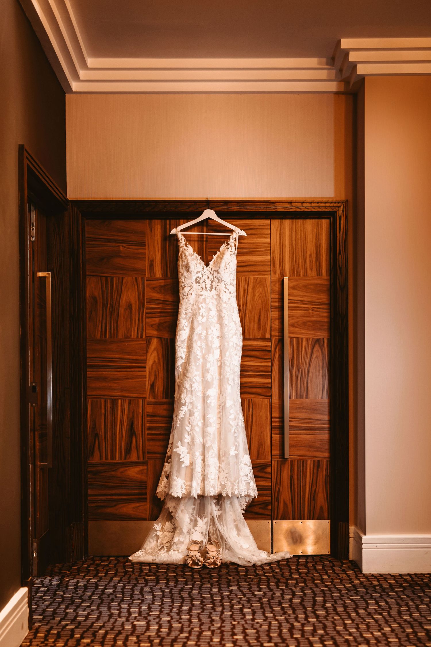 wedding dress hung on door frame