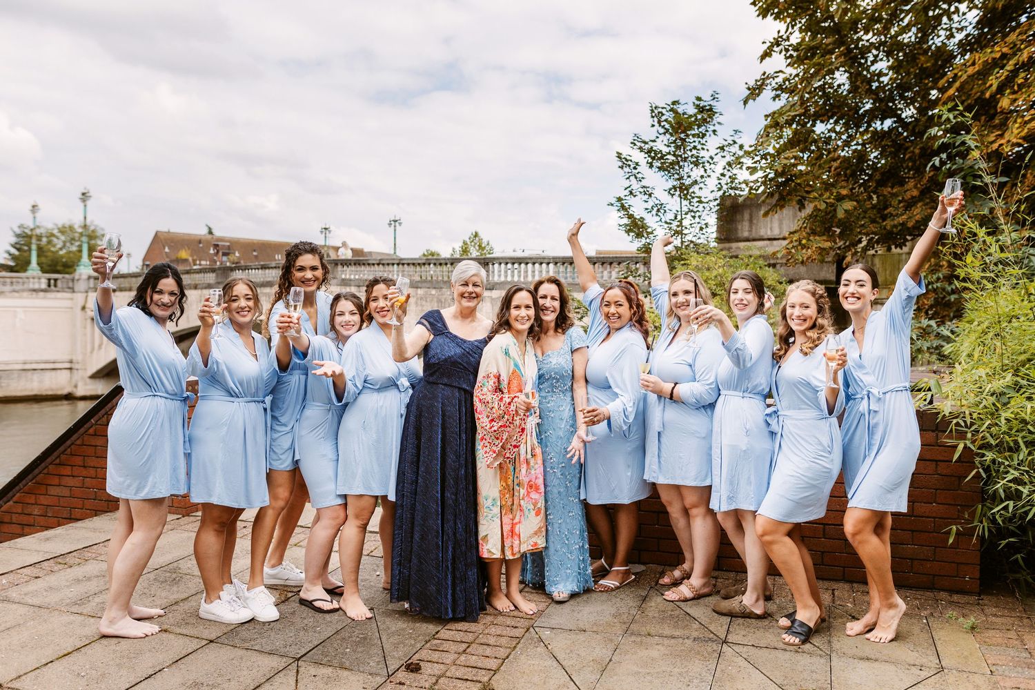 bride and bridesmaids cheering in blue satin dressing gowns