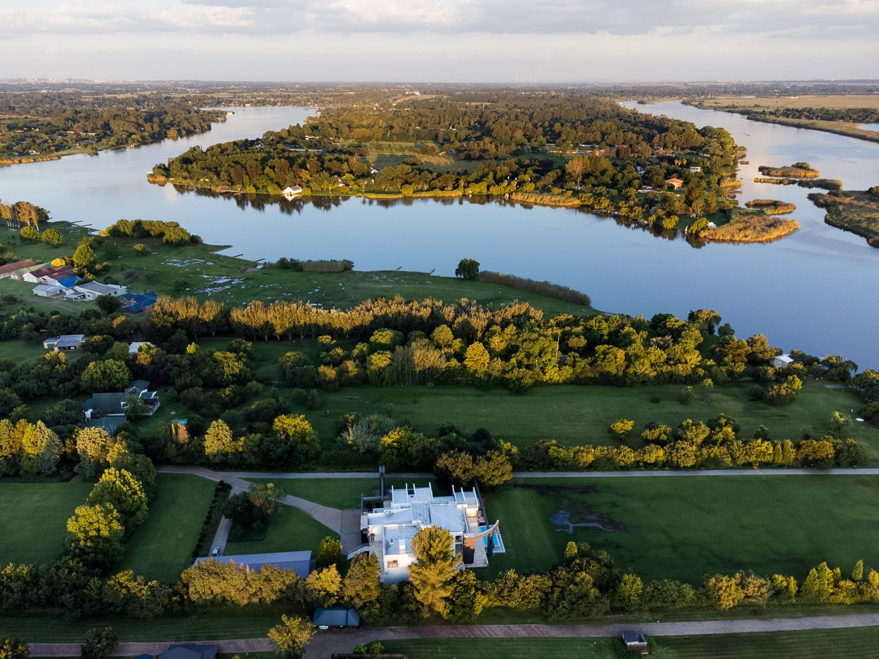 Drone view at sunset of real estate next to the Vaal river.