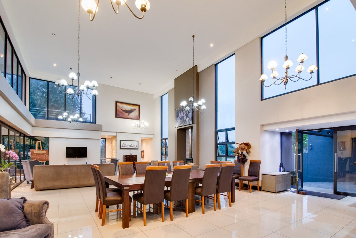 Living room with high ceiling and big windows