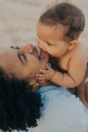 Intimate moment between parent and baby as they share loving smiles.