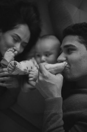 Black and white intimate family moment sharing playful expressions.