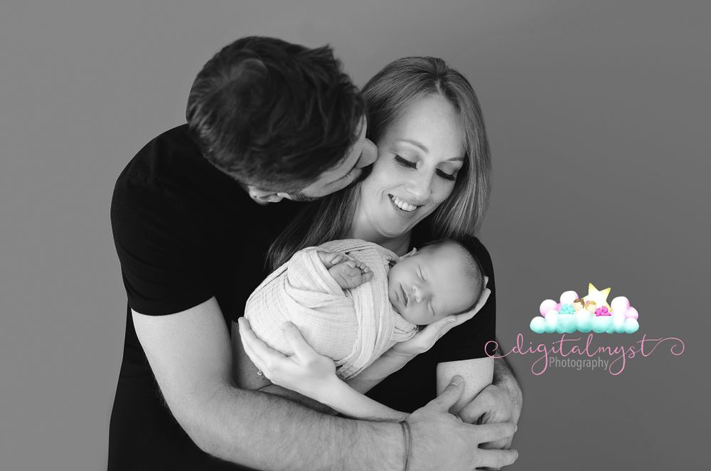 Black and white family portrait showing tender moments together.