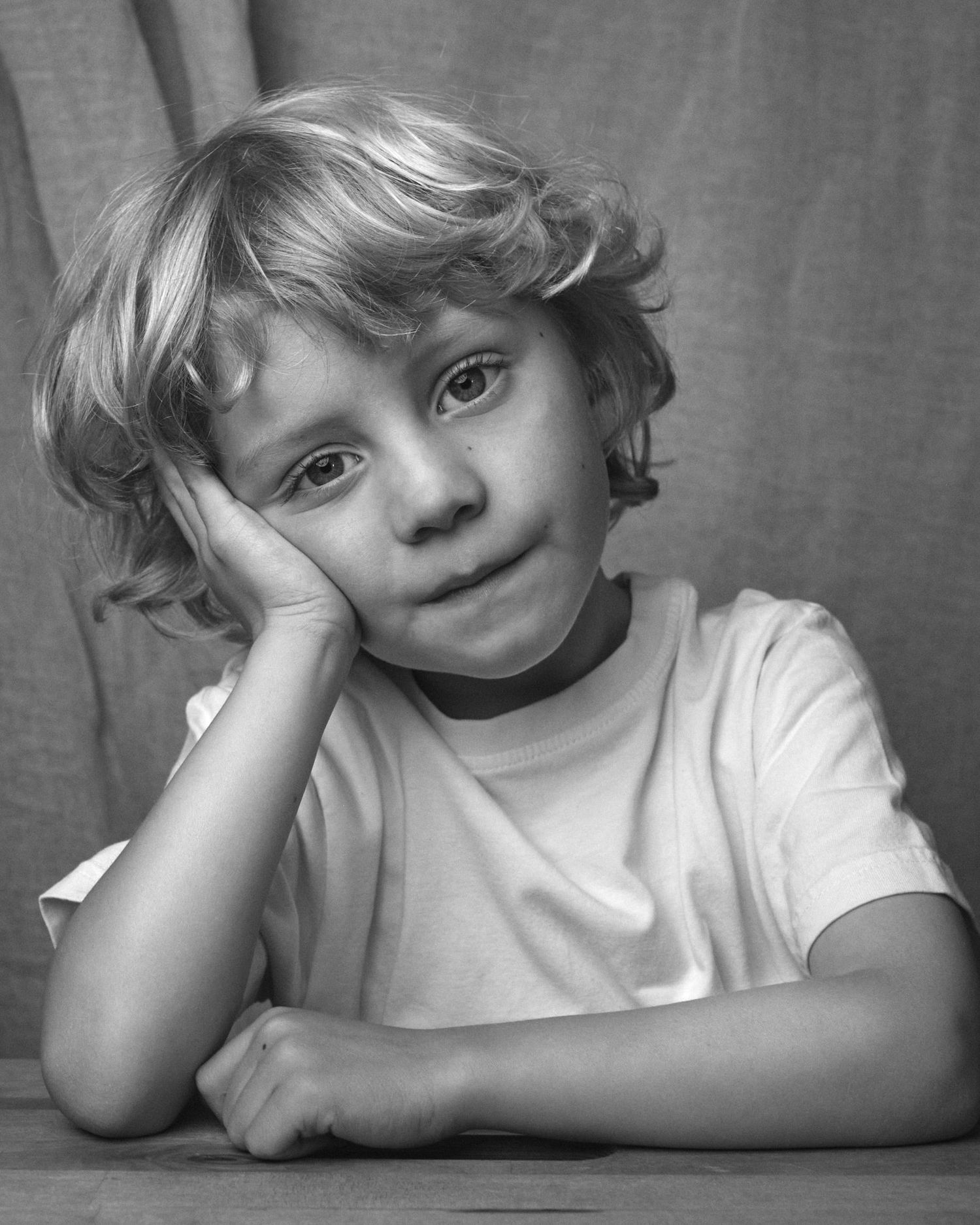 Black and white portrait of a Child leaning on his hand