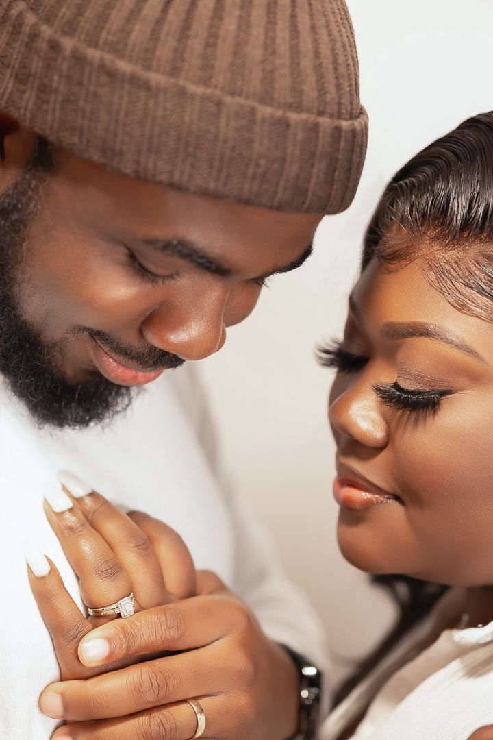 Intimate close-up of couple holding hands showing wedding rings.