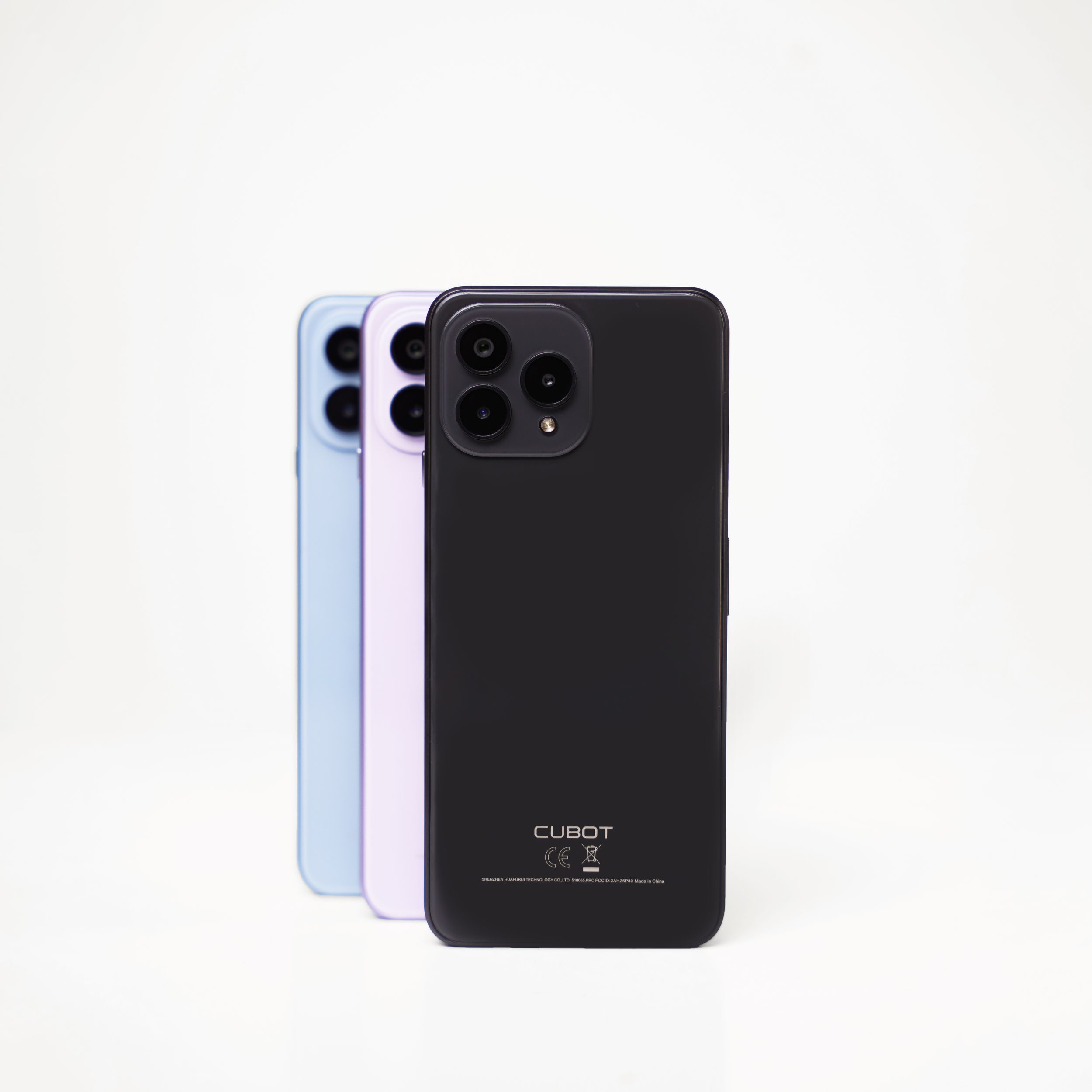 Three smartphones with triple camera setups arranged in black, light blue and white colors on white background.