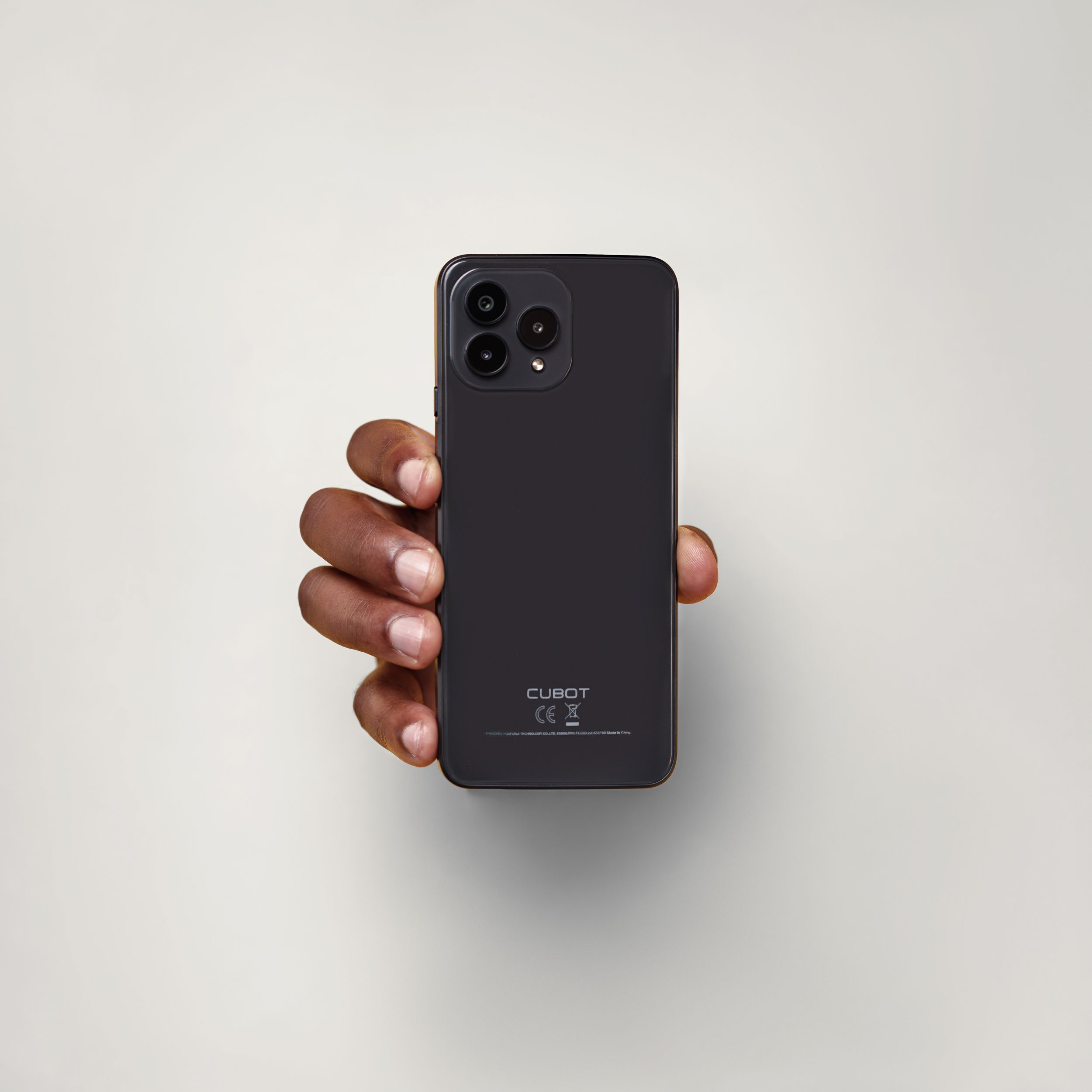 A matte black smartphone with triple camera displayed on a white background.
