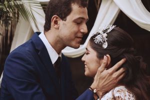 A tender romantic moment between a couple in wedding attire.
