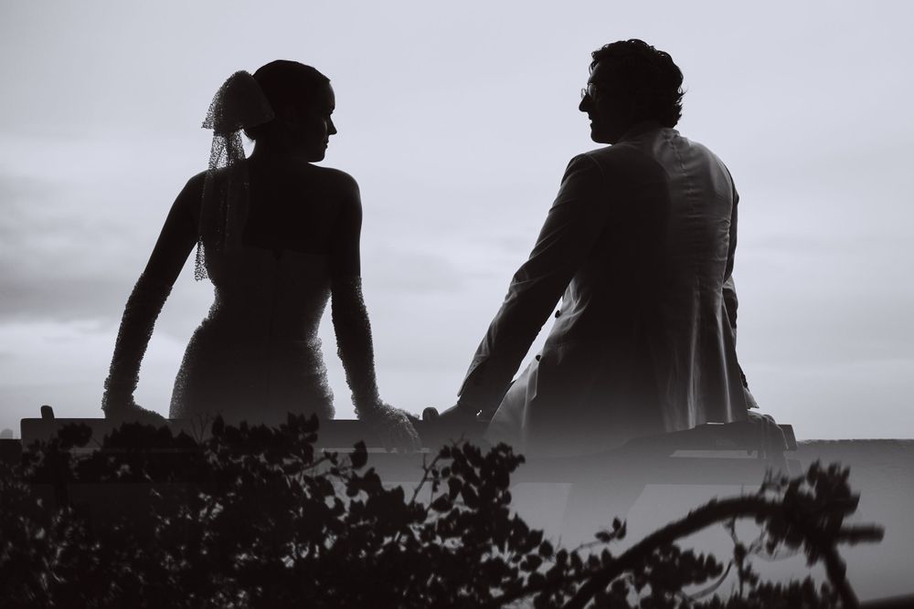 Silhouette of a couple against a moody sky creating a dramatic artistic composition.
