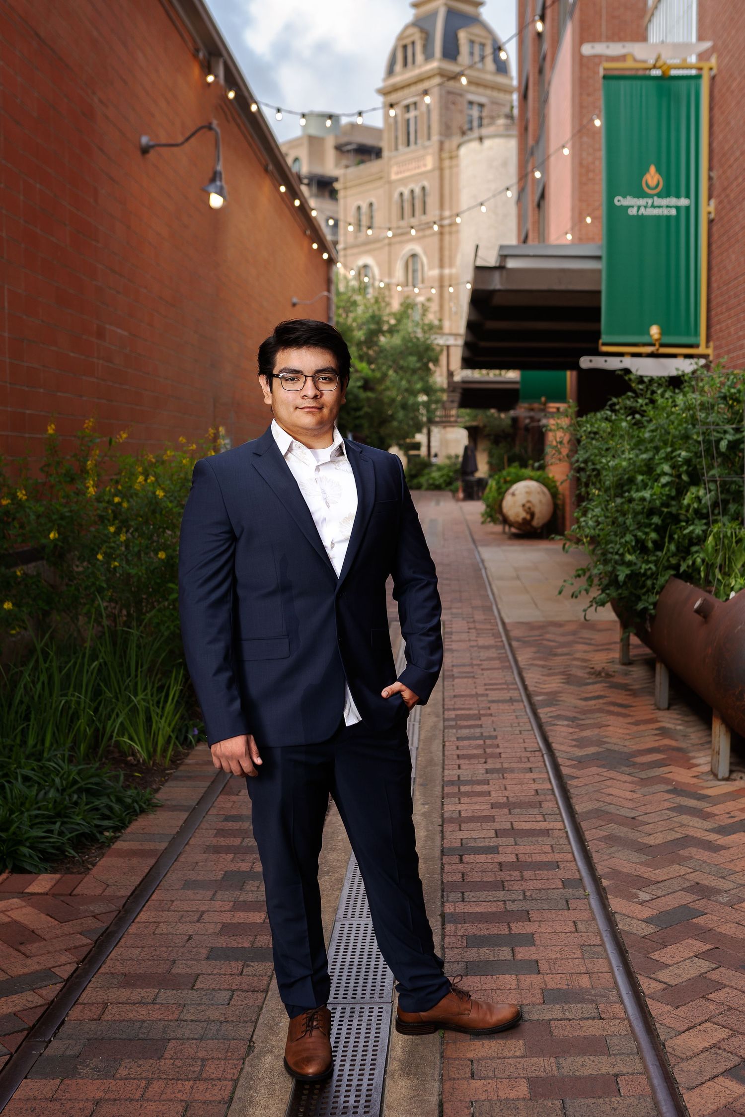 The Historic Pearl San Antonio Texas high school senior boy portrait standing in walkway