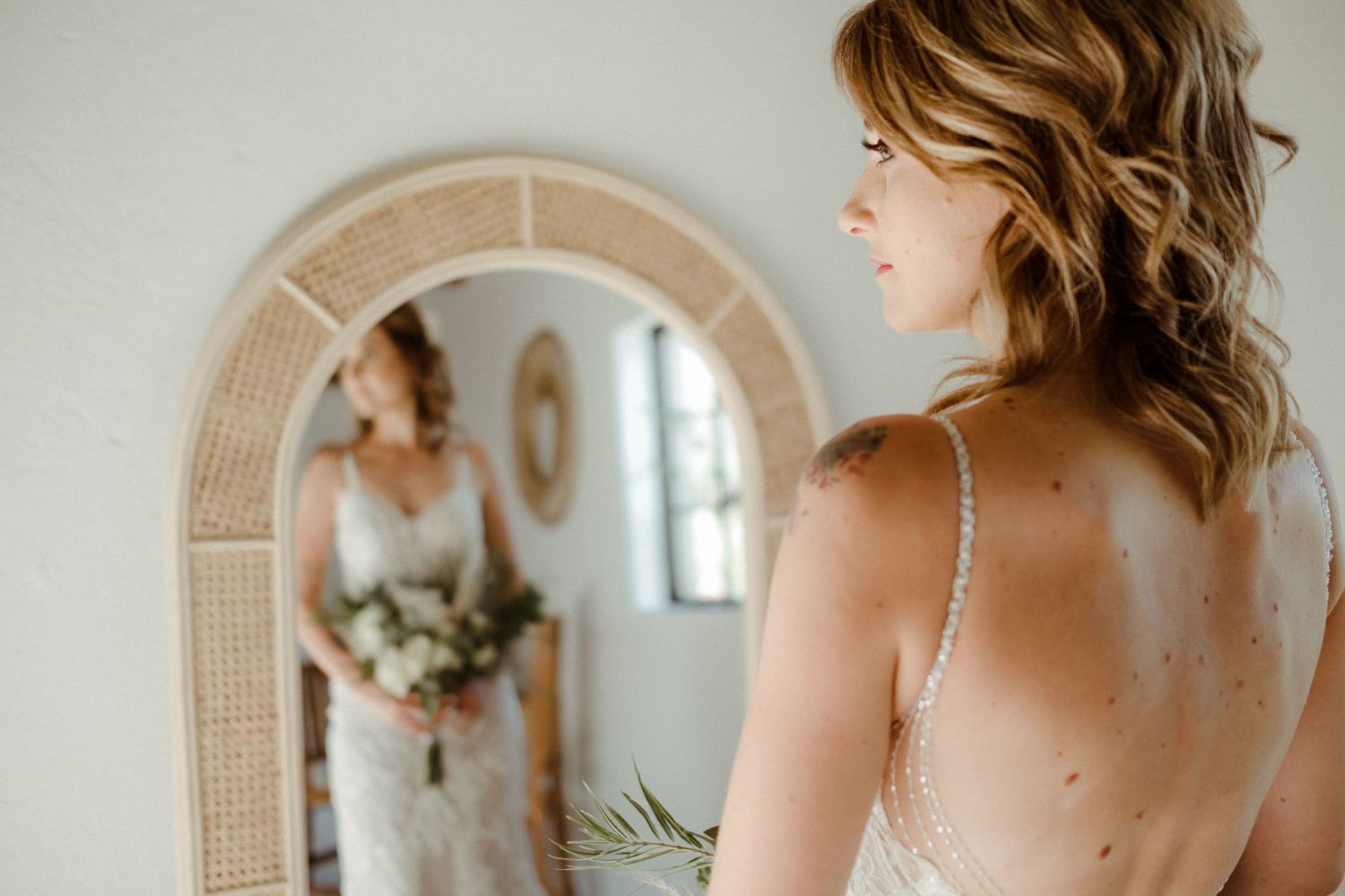 Bride standing infront of mirror at intiem Weddings Bridal Studio in Pretoria for smaller intimate weddings