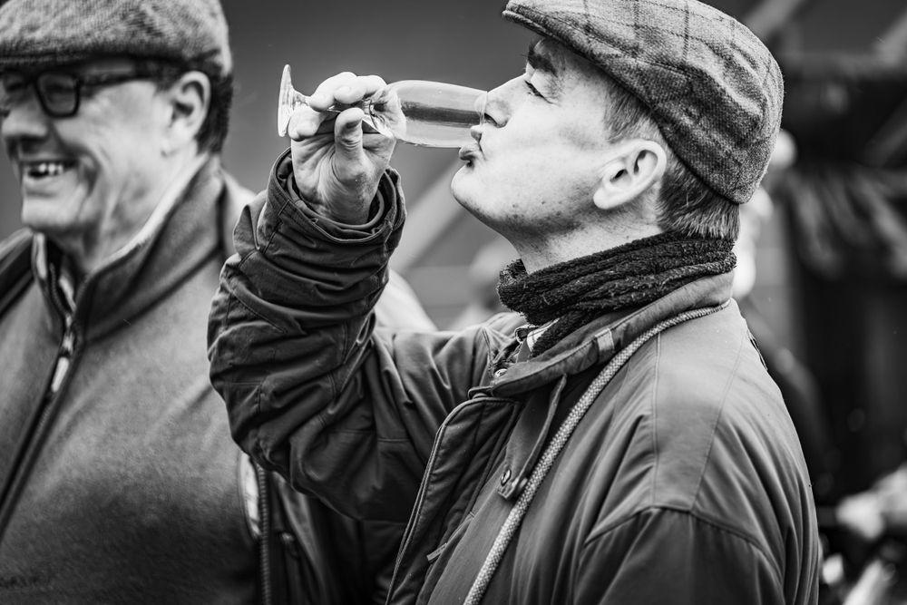 Traditional hunting scene with flat caps and warm clothing in black and white.