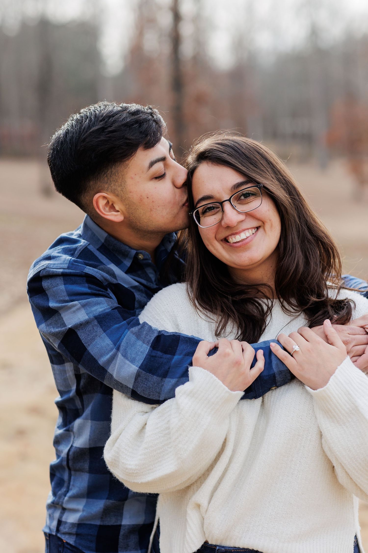 Cozy winter portrait of a couple embracing and sharing a sweet moment together.