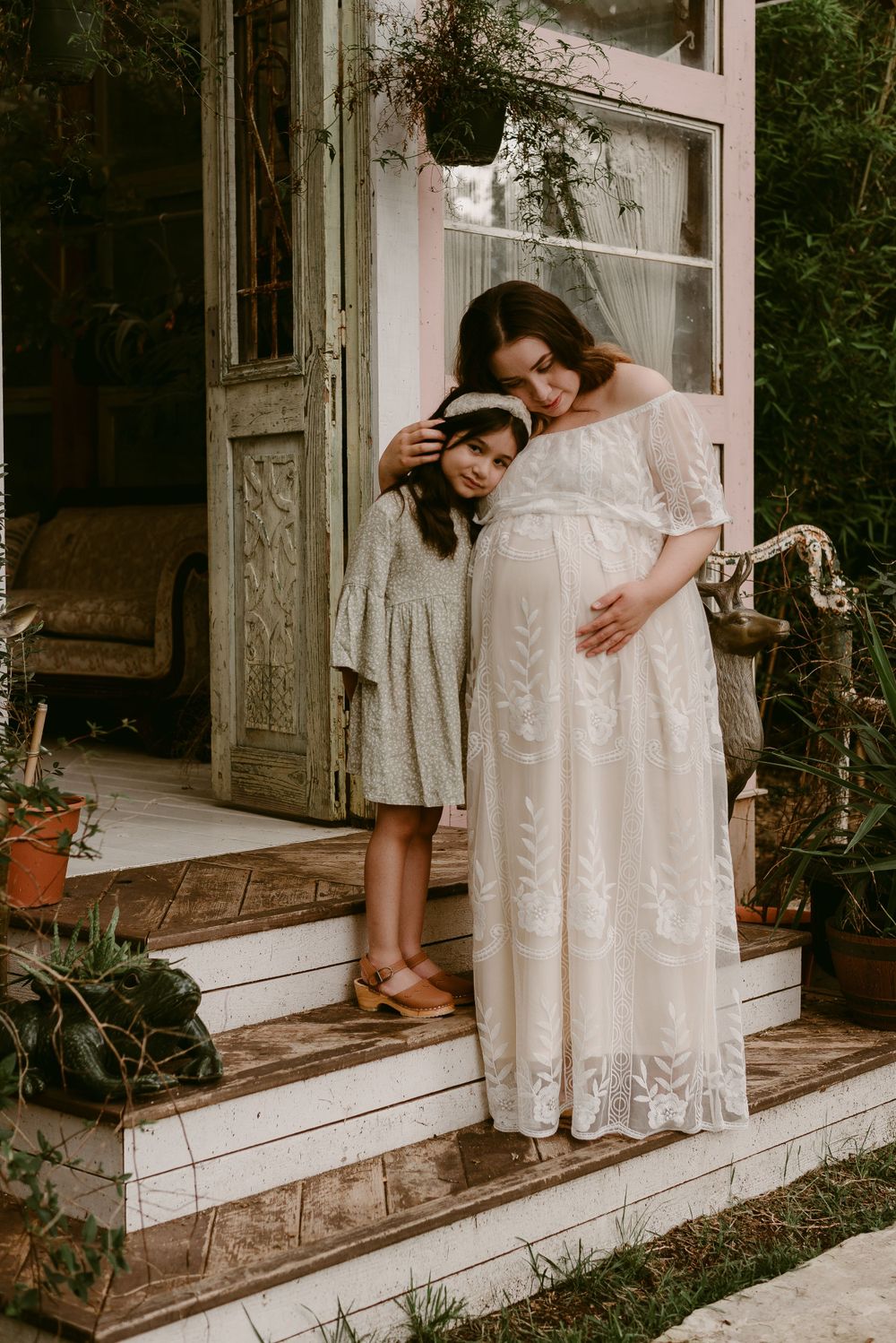 A tender embrace shared between family members during a maternity photo session.