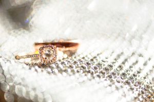 Beautiful engagement ring with diamonds photographed on delicate lace fabric.