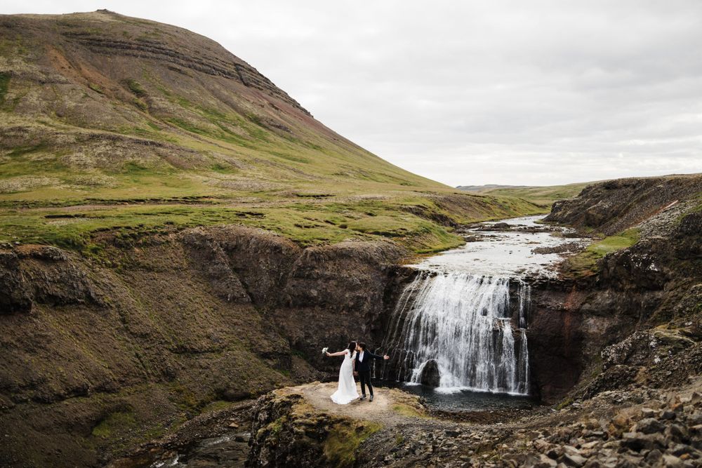 Dramatic waterfall cascading down cliffs in remote Icelandic landscape.