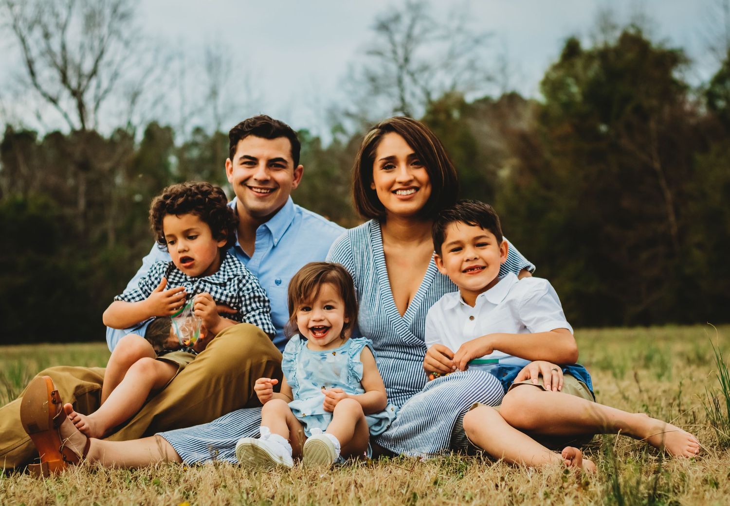 Happy family in forest of New Haven, CT spends time in nature during photo session