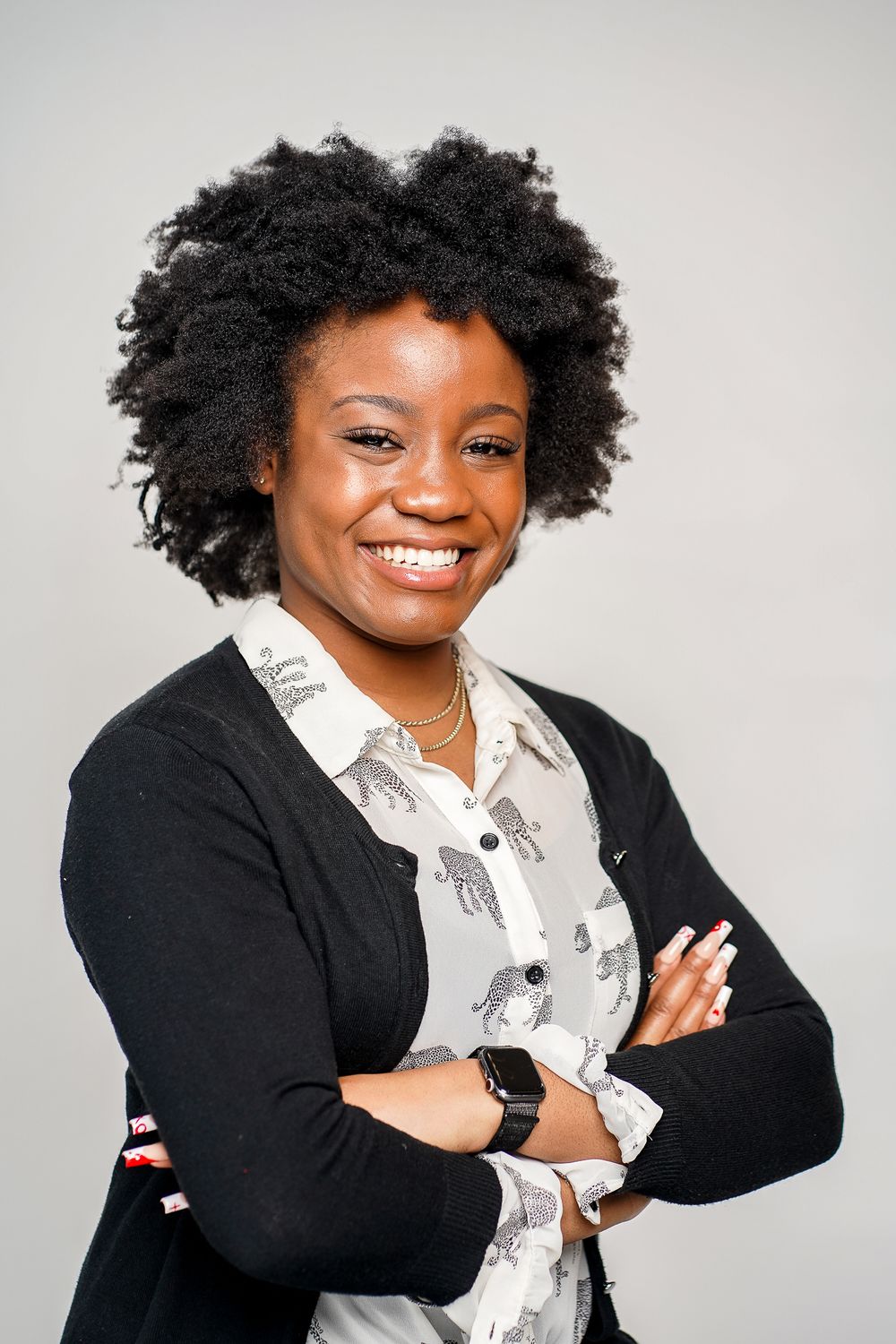 Professional headshots showing confident poses in a black blazer and patterned white shirt.