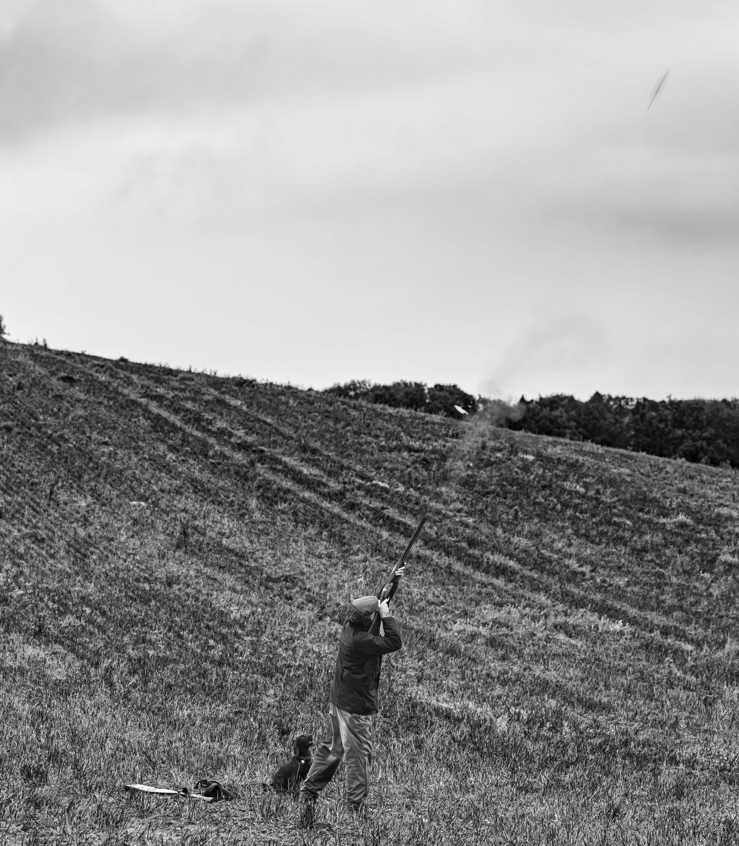 People walking up a steep hillside in black and white landscape shots.