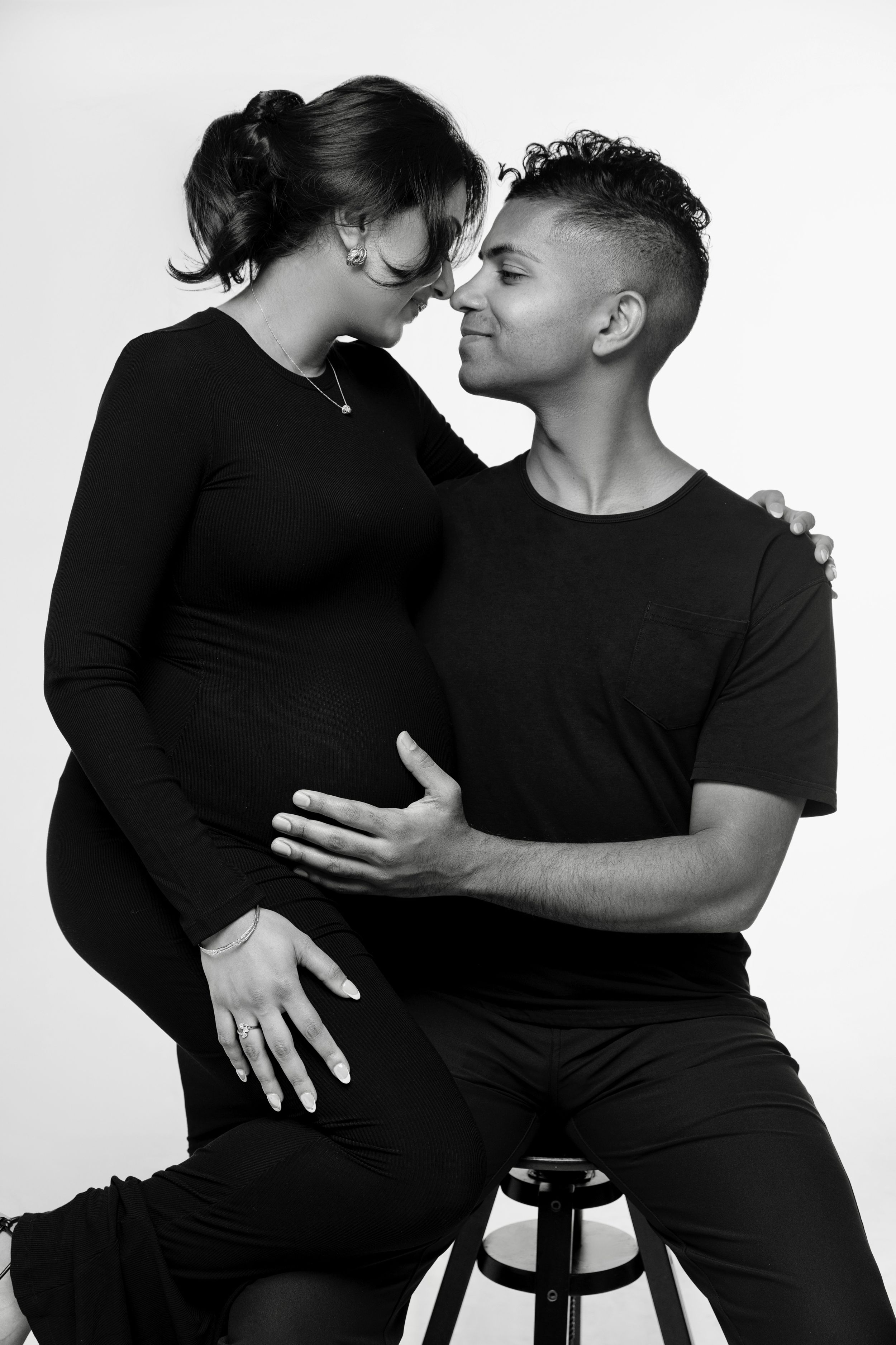 San Diego studio maternity session with a partner in a black and white minimalistic style, captured by Daryana Orange.