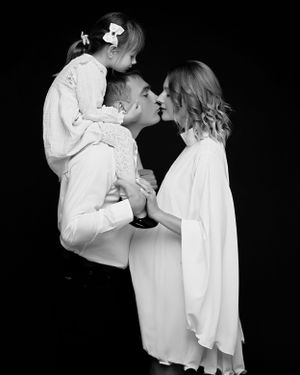 San Diego studio maternity session with a family in a black and white minimalistic style, captured by Daryana Orange.