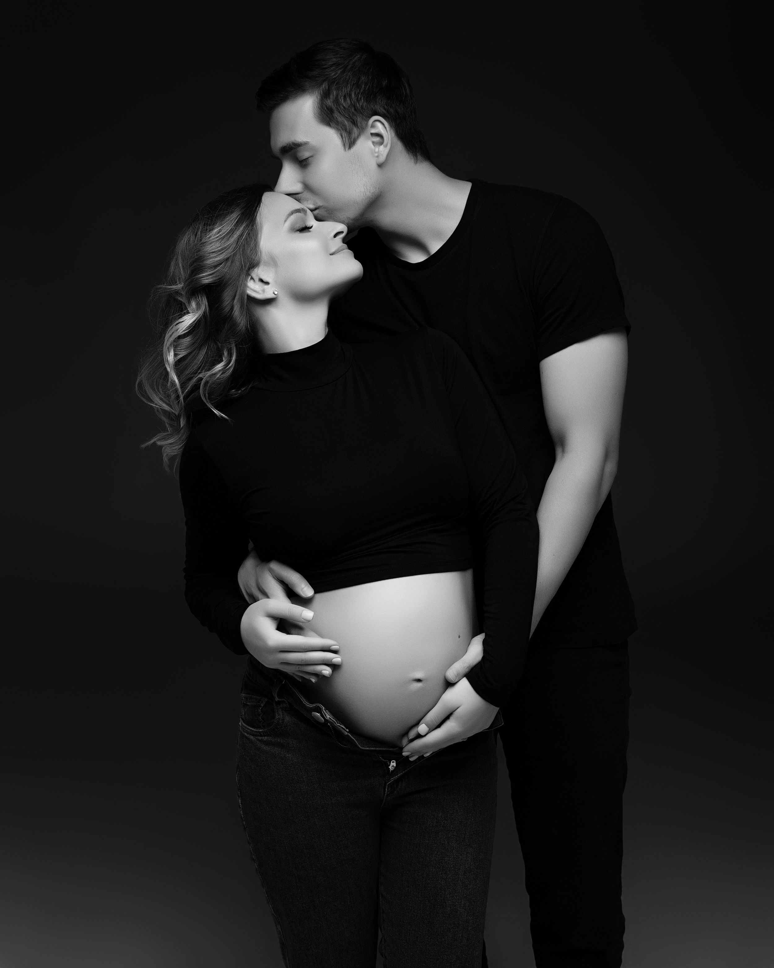 San Diego studio maternity session with a partner in a black and white minimalistic style, captured by Daryana Orange.