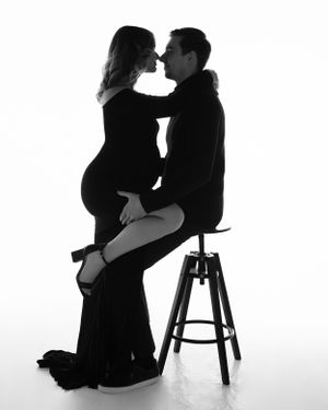 San Diego studio maternity session with a partner in a black and white minimalistic style, captured by Daryana Orange.
