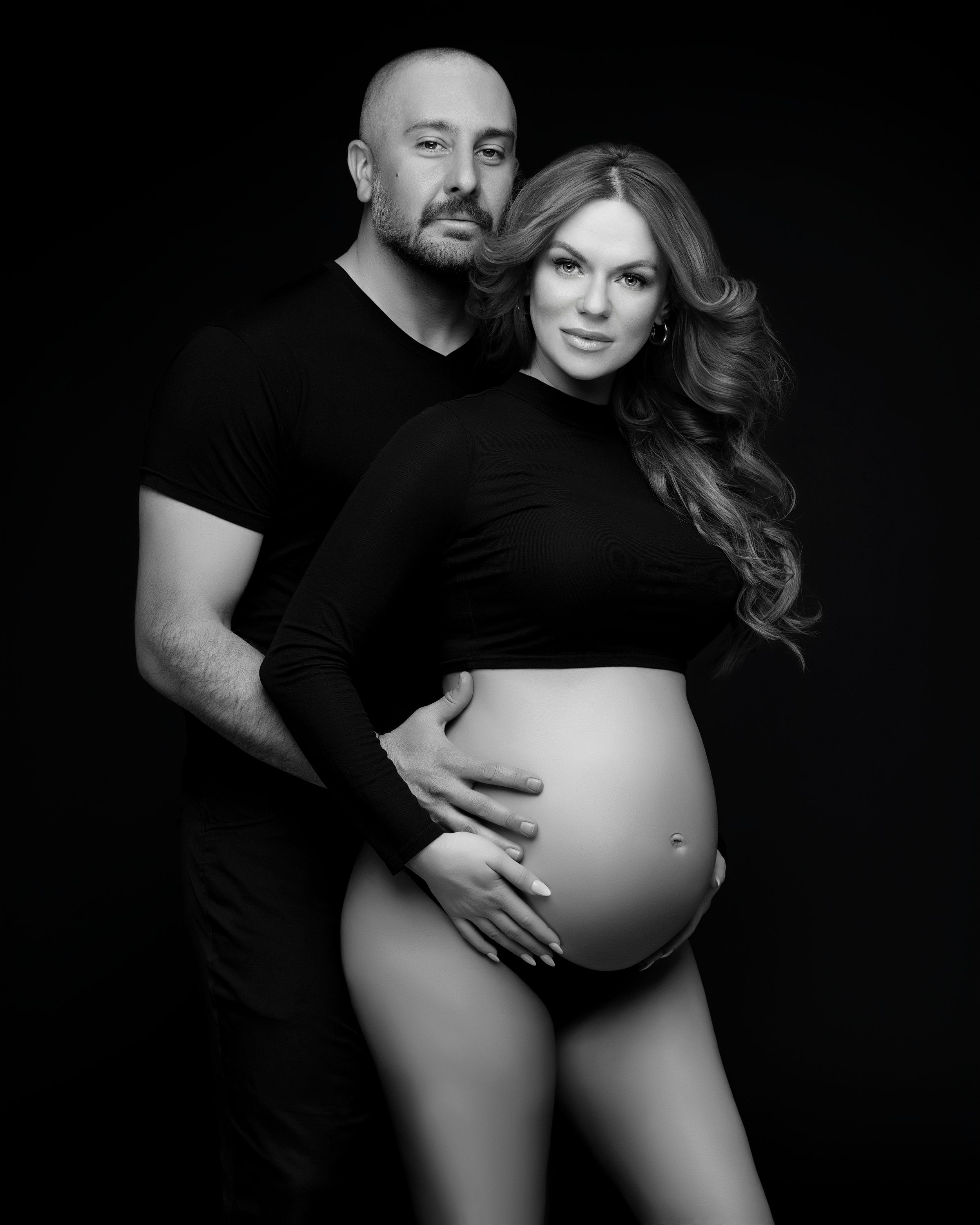 San Diego studio maternity session with a partner in a black and white minimalistic style, captured by Daryana Orange.