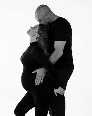 San Diego studio maternity session with a partner in a black and white minimalistic style, captured by Daryana Orange.