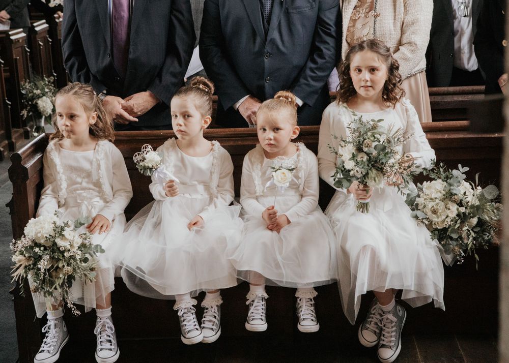 flower girls sat in a church in cornwall photography