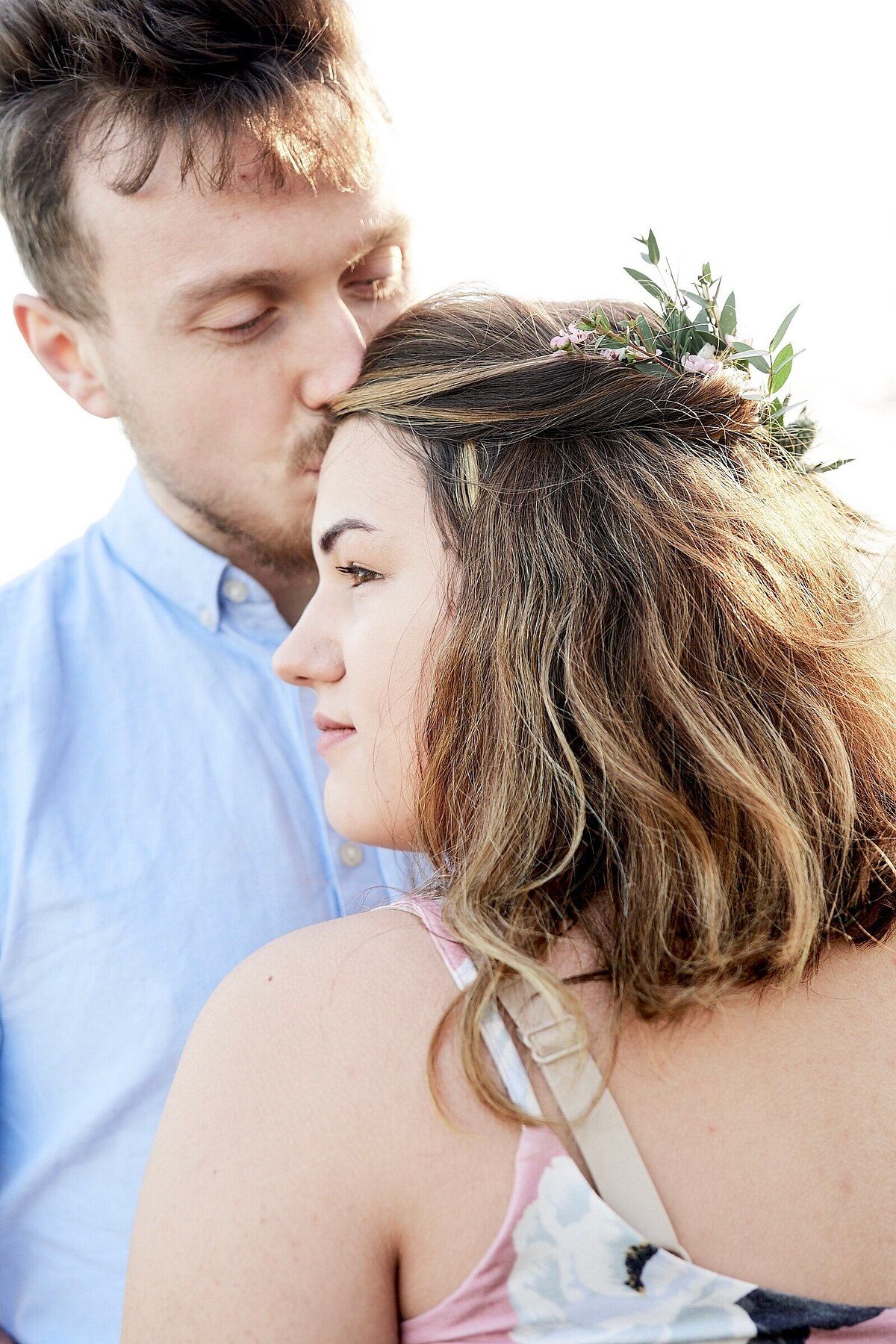 newly engaged couple kissing his fiance on the temple by Norwich Wedding Photographer Faye Amare Photography